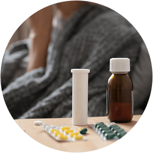 Photo of pills and bottles next to woman