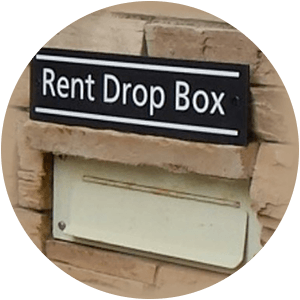 Photo of rent drop box in stone wall